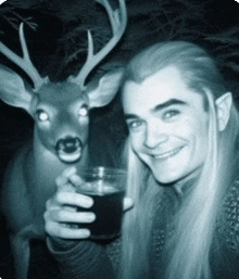 a man is holding a glass next to a deer