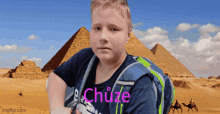 a boy wearing a blue shirt that says chuze