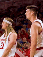 two basketball players wearing jerseys with the number 21 on them