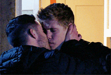 two men are hugging and kissing each other