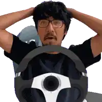 a man with glasses and a beard is driving a car with his hands on his head