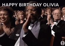 a man in a tuxedo applauds with the words happy birthday olivia written above him