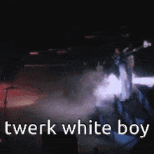 a man playing a guitar on stage with the words twerk white boy