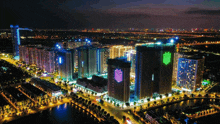 an aerial view of a city at night with buildings lit up with nfl logos