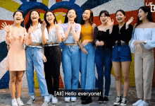 a group of young women are standing in front of a colorful wall with the words all hello everyone written on the bottom