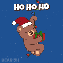 a teddy bear wearing a santa hat is holding a gift and a string of lights