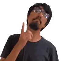 a man with glasses and a beard looks up at something