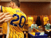 a soccer player wearing a yellow jersey with the number 20 on it