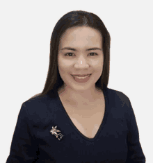 a woman wearing a blue shirt has a brooch on her collar