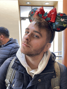 a man wearing mickey mouse ears and a time backpack