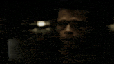 a close up of a man 's face in a dark room with the words zartzurt written on the bottom .