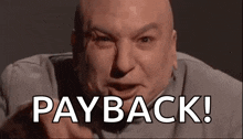 a bald man is pointing at the camera with the words `` payback ! '' written on his face .