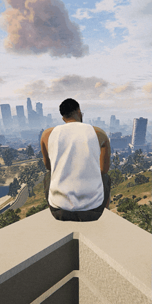 a man in a white tank top sits on the edge of a building