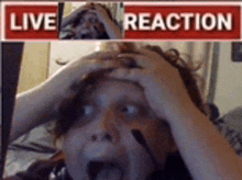 a woman is making a funny face in front of a live reaction sign