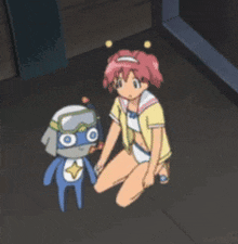 a girl is kneeling down next to a robot