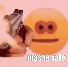 a person is pointing a gun at a smiley face with the words `` mas te vale '' .