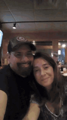 a man and a woman posing for a picture in a restaurant