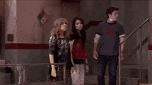 a group of people are standing in a room with a sign that says " electrical room "