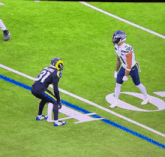 a football player with the number 11 on his jersey is jumping in the air