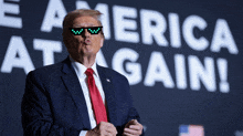 donald trump is wearing sunglasses in front of a sign that says america at gain