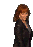 a woman with red hair is wearing a leather jacket