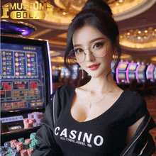 a woman standing in front of a slot machine wearing a shirt that says casino