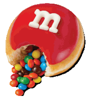 a m & m donut with a bite taken out of it and m & m 's pouring out of it