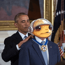 a man in a suit has a medal around his neck that says ' united states of america ' on it