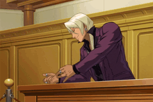 a man in a purple suit is sitting at a podium in a courtroom