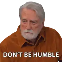 an older man with a beard and a shirt that says " don 't be humble "