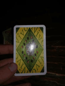 a person is holding a playing card that says vivo on it