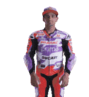 a man wearing a purple and red motorcycle suit with ducati on it