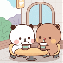 two bears sit at a table drinking coffee from cups