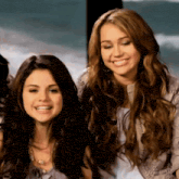 miley cyrus and selena gomez are smiling for a picture