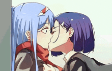 a couple of anime girls kissing each other on the cheek .