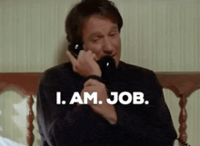 a man talking on a phone with the words i am job written below him