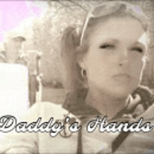 a woman is wearing sunglasses and the words daddy 's hands are above her .