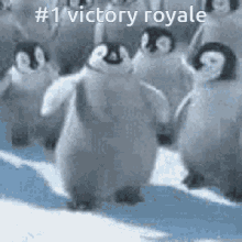 a group of penguins are dancing in the snow with the caption # 1 victory royale above them