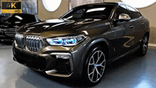 a bmw x6 is displayed in a 4k ultra hd showroom