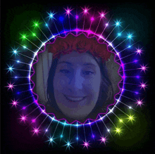 a woman with a red flower crown on her head is in a circle of lights