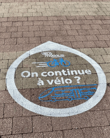 on continue a velo is written on a brick walkway