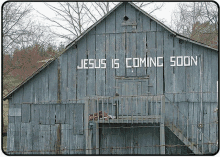 an old barn with the words `` jesus is coming soon '' painted on the side .