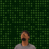 a man stands in front of a green background with the number 31 in yellow