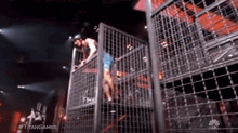 a man is in a cage with the hashtag #titangames on it