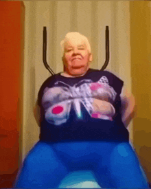 a woman wearing a barbie shirt is sitting on a ball