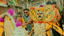 a man wearing sunglasses and a tiger costume is surrounded by people