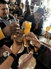 a group of people toasting at a table with a menu on the table