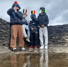 a group of young men are posing for a picture with their faces obscured by flags