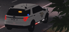 a white ford police car with a license plate number of 987