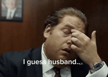 a man in a suit and tie has his hand on his forehead and the words i guess husband